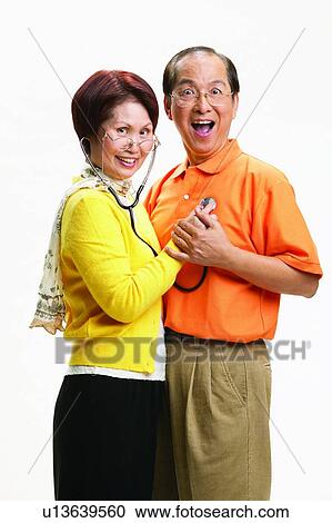 Stock Image - Asian Ethnicity, Cardigan, Brown Hair, Balding, Adults Only. Fotosearch