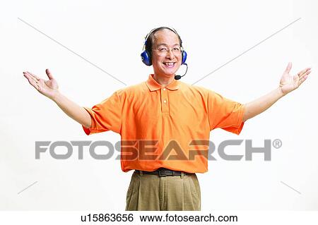 Stock Photograph - Asian Ethnicity, Casual Clothing, Belt, Balding, Arm Outstretched. Fotosearch