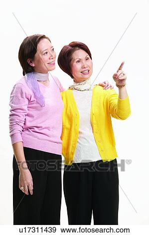 Asian Ethnicity, Togetherness, Standing, Side By Side, Arm Around View Large Photo Image Stock Photo - Asian Ethnicity, Togetherness, Standing, Side By Side, Arm Around. Fotosearch