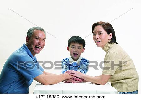 Stock Image - Boys, Table, Eastern, Mature Couple, Happiness, T-Shirt. Fotosearch