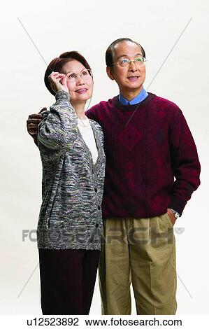 Stock Image - East, White Background, Two People, Holding, Asian, Short Hair, Togetherness. Fotosearch