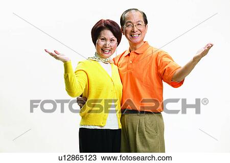 Stock Image - Eastern, Pants, Elderly, Mature Couple, Brown Hair, Asian, Togetherness. Fotosearch
