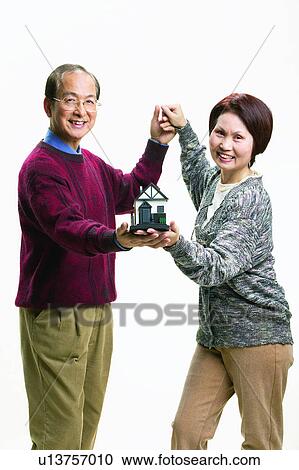 Stock Image - Eyeglasses, Holding Hands, Mature Adult, Two People, Happiness, Short Hair. Fotosearch