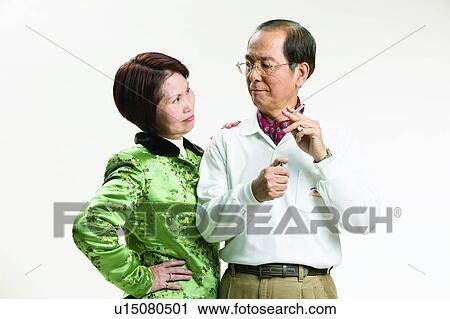 Stock Image - Lifestyles, Two People, Togetherness, Looking At Each Other, Eyeglasses, Neckerchief, Hand On Hip. Fotosearch