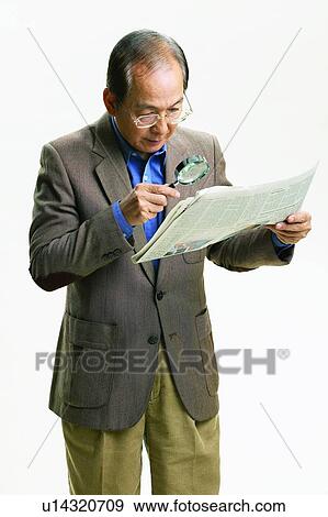 Looking Through An Object, Discovery, Newspaper, Casual Clothing, Mature Adult View Large Photo Image Stock Photo - Looking Through An Object, Discovery, Newspaper, Casual Clothing, Mature Adult. Fotosearch