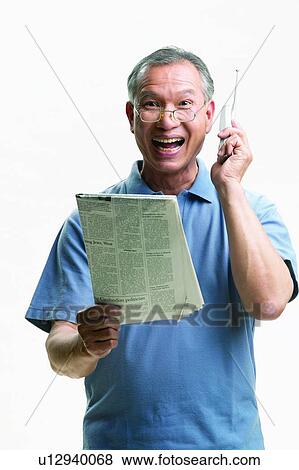Stock Photo - Mature Adult, Elderly, Lifestyles, The Media, Technology, Holding. Fotosearch