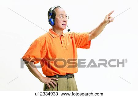 Stock Image - Mature Adult, Polo Shirt, Hand On Hip, Hand Raised, Eastern. Fotosearch