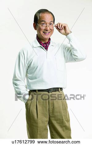 Stock Photo - Neckerchief, Belt, Asian, Elderly, Looking At Camera, Holding, Toothy Smile. Fotosearch