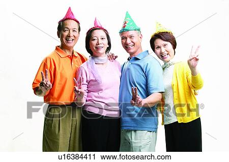 Stock Image - Pants, Smiling, Celebration, Side By Side, Mature Women, Birthday Hat, Standing. Fotosearch