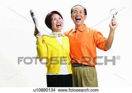 Short Hair, Balding, Pants, Looking Up, Magnifying Glass, Polo Shirt, Heterosexual Couple View Large Photo Image Picture - Short Hair, Balding, Pants, Looking Up, Magnifying Glass, Polo Shirt, Heterosexual Couple. Fotosearch