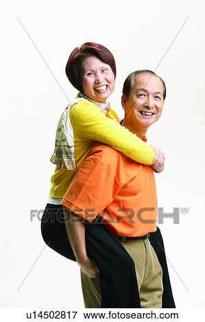 Stock Photo - Togetherness, Smiling, Mature Men, Heterosexual Couple, Three-Quarter Length, Brown Hair, Looking At Camera. Fotosearch
