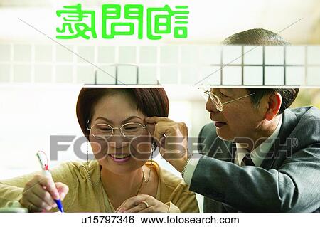 Stock Photograph - Adults Only, Businessmen, Brown Hair, Asian Ethnicity, Adjusting. Fotosearch