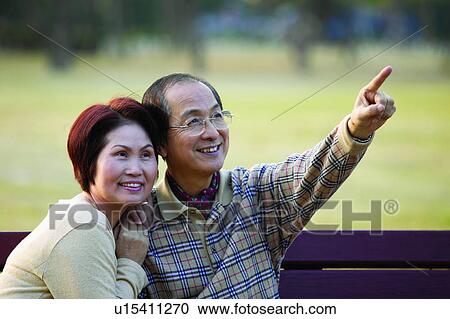 Stock Image - Asian Ethnicity, Brown Hair, Black Hair, Bench, Adults Only. Fotosearch