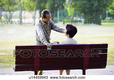 Asian Ethnicity, Button Down Shirt, Brown Hair, Bench, Adults Only View Large Photo Image Stock Image - Asian Ethnicity, Button Down Shirt, Brown Hair, Bench, Adults Only. Fotosearch