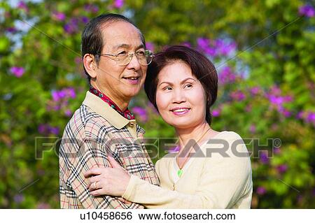 Stock Photograph - Brown Hair, Button Down Shirt, Casual Clothing, Asian Ethnicity, Embracing. Fotosearch