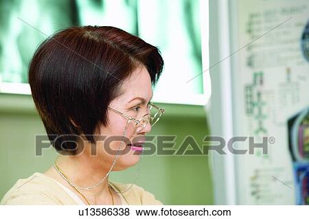 Stock Photo - Brown Hair, Close-Up, Casual Clothing, Asian Ethnicity. Fotosearch