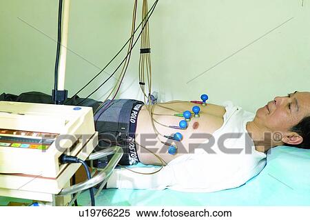 ECG, Chest, Lying Down, Scrutiny, Receding Hairline, Mature Adult View Large Photo Image Stock Photography - ECG, Chest, Lying Down, Scrutiny, Receding Hairline, Mature Adult. Fotosearch