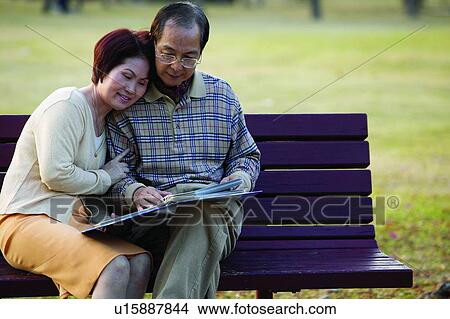 Focus On Foreground, Black Hair, Brown Hair, Mature Couple, Asian Ethnicity, Sitting, Close-Up View Large Photo Image Picture - Focus On Foreground, Black Hair, Brown Hair, Mature Couple, Asian Ethnicity, Sitting, Close-Up. Fotosearch