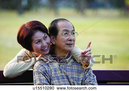 Stock Image - Golden Years, Close-Up, Focus On Foreground, Two People, Sitting, Toothy Smile. Fotosearch