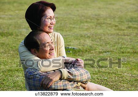 Mature Couple, Embracing, Casual Clothing, Lying Down, Toothy Smile, Receding Hairline View Large Photo Image Stock Photo - Mature Couple, Embracing, Casual Clothing, Lying Down, Toothy Smile, Receding Hairline. Fotosearch