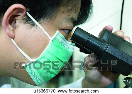 Stock Image - Microscope, Holding, Research, Expertise, Professional Occupation, Close-Up, Profession. Fotosearch