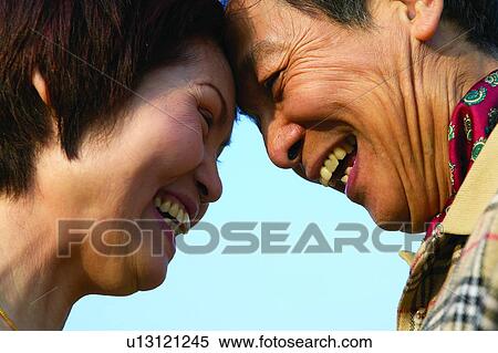 Smiling, Togetherness, Looking At Each Other, Affectionate, Laughing, Clear Sky, Casual Clothing View Large Photo Image Stock Photography - Smiling, Togetherness, Looking At Each Other, Affectionate, Laughing, Clear Sky, Casual Clothing. Fotosearch