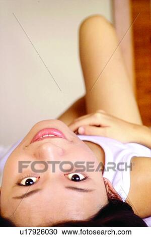 Stock Image - Bedroom, Focus On Foreground, Close-Up, Asian Ethnicity. Fotosearch