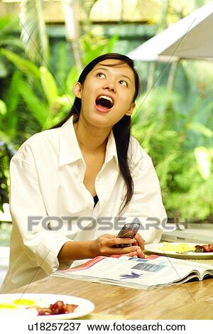 Stock Photo - Brown Hair, Communication, Button Down Shirt, Asian Ethnicity. Fotosearch