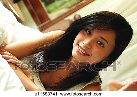 Cheerful, Barefoot, Casual Clothing, Brown Hair, Bedroom, Asian Ethnicity View Large Photo Image Stock Image - Cheerful, Barefoot, Casual Clothing, Brown Hair, Bedroom, Asian Ethnicity. Fotosearch