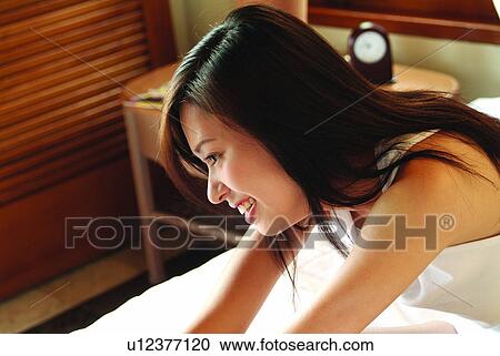 Focus On Foreground, Lying On Front, Indoor, Nightwear, Asian Ethnicity View Large Photo Image Stock Image - Focus On Foreground, Lying On Front, Indoor, Nightwear, Asian Ethnicity. Fotosearch