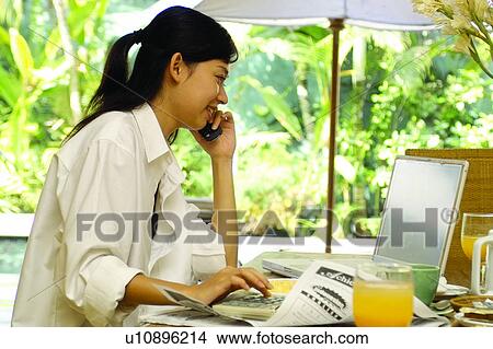 Picture - Lifestyles, Wireless Technology, Glass, Orange Juice, Day. Fotosearch