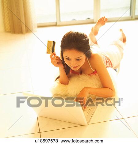 Stock Photo - Barefoot, Casual Clothing, Brown Hair, Asian Ethnicity. Fotosearch