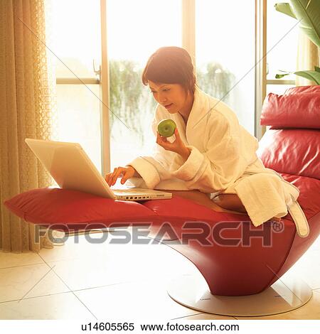 Stock Photography - Barefoot, Teenage Girl, Couch, Healthy Eating, Indoor, Woman, Accessibility. Fotosearch
