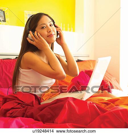 Picture - Bed, Casual Clothing, Brown Hair, Bedroom, Asian Ethnicity. Fotosearch