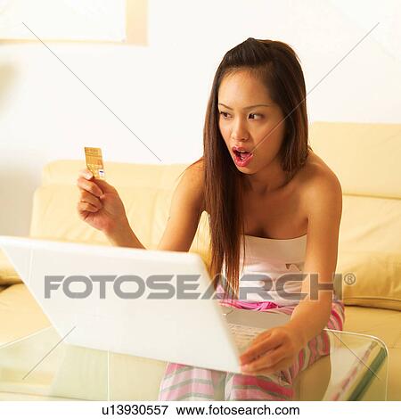 Stock Photo - Consumerism, Young Adult, Home Shopping, Square, Long Hair. Fotosearch