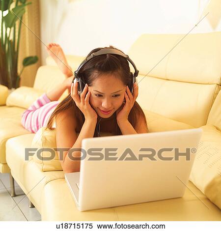 Stock Photography - Entertainment, Laptop, Technology, Woman, Casual Clothing, Tube Top, Mobility. Fotosearch