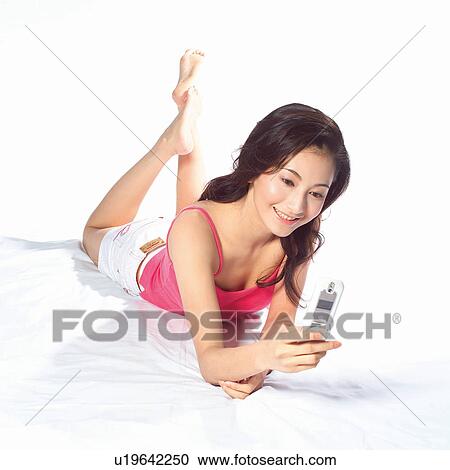Looking Down, Teenage Girl, One Person, Holding, Youth Culture, White Background, Happiness View Large Photo Image Stock Image - Looking Down, Teenage Girl, One Person, Holding, Youth Culture, White Background, Happiness. Fotosearch
