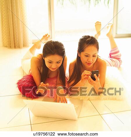 Stock Image - Square, Brown Hair, Long Hair, In This Life, Casual Clothing, Holding, Asian Ethnicity. Fotosearch