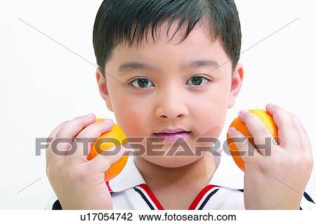Stock Image - Black Hair, One Person, One Child Only, T-Shirt, Head And Shoulders, Holding. Fotosearch