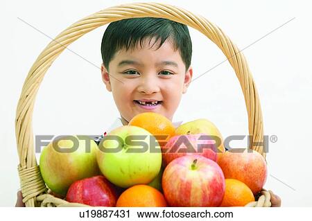 Stock Image - Casual Clothing, Apple, Black Hair, Basket, Asian Ethnicity, Child, 4-5 Years. Fotosearch