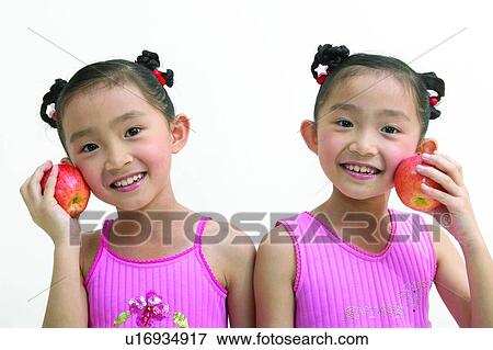 Stock Photo - Child, Apple, Cheerful, Black Hair, Asian Ethnicity, Children Only, 4-5 Years. Fotosearch