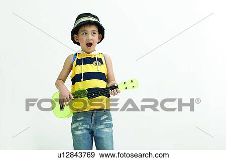 Stock Photo - Kids Stuff, Clipping Path, Playful, Confidence, Hat, Music, 4-5 Years. Fotosearch