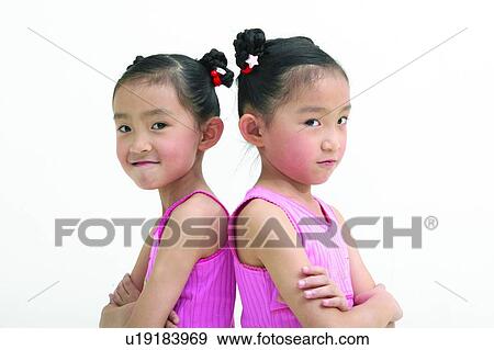 Stock Photo - Kids Stuff, Looking At Camera, Black Hair, Cut Out, Indoor, Back To Back, Innocence. Fotosearch