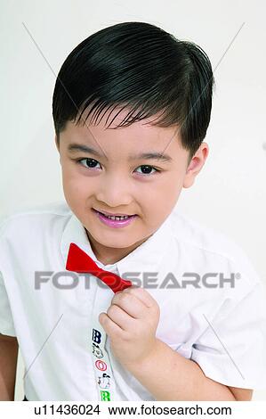 Picture - One Child Only, Bow Tie, Indoor, Holding, Toothy Smile, White Background. Fotosearch