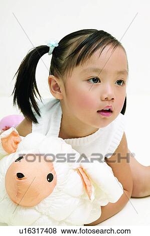 Stock Photo - Three-Quarter Length, Kids Stuff, One Person, Casual Clothing, Black Hair, Pigtails. Fotosearch