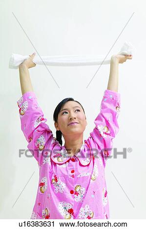Stock Image - Asian Ethnicity, Close-Up, Braids, Black Hair, Arms Raised. Fotosearch