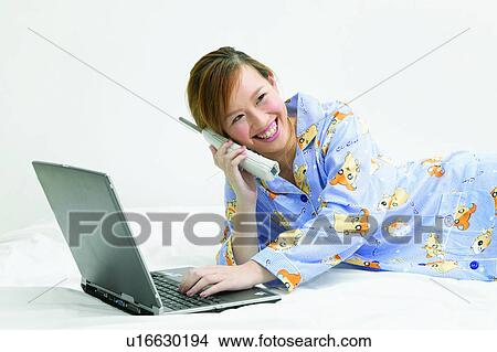 Bed, Cheerful, Brown Hair, Asian Ethnicity View Large Photo Image Picture - Bed, Cheerful, Brown Hair, Asian Ethnicity. Fotosearch