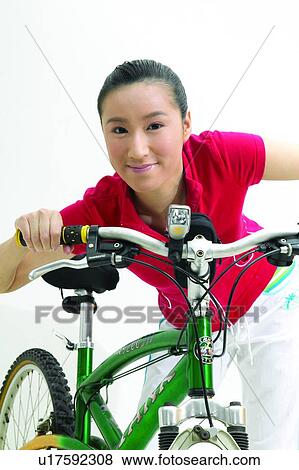 Bending, Casual Clothing, Black Hair, Bicycle, Asian Ethnicity View Large Photo Image Stock Photo - Bending, Casual Clothing, Black Hair, Bicycle, Asian Ethnicity. Fotosearch