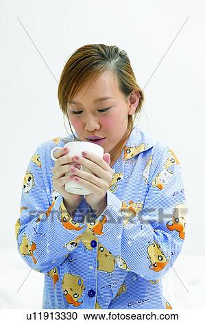 Stock Image - Beverage, Close-Up, Brown Hair, Asian Ethnicity. Fotosearch