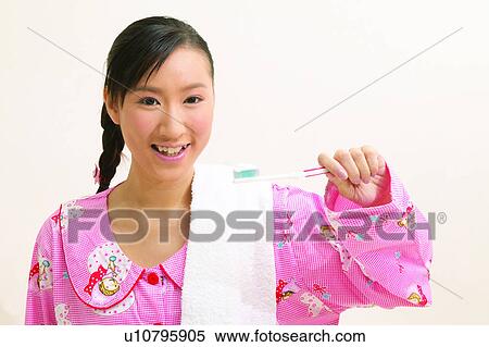 Stock Photography - Black Hair, Close-Up, Brushing Teeth, Braids, Asian Ethnicity. Fotosearch